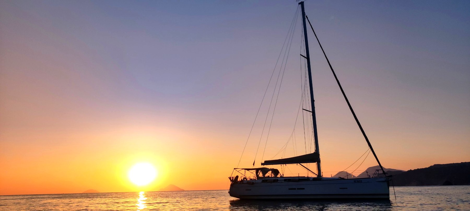 Yachts at anchor at sunset in the Aeolian Islands
